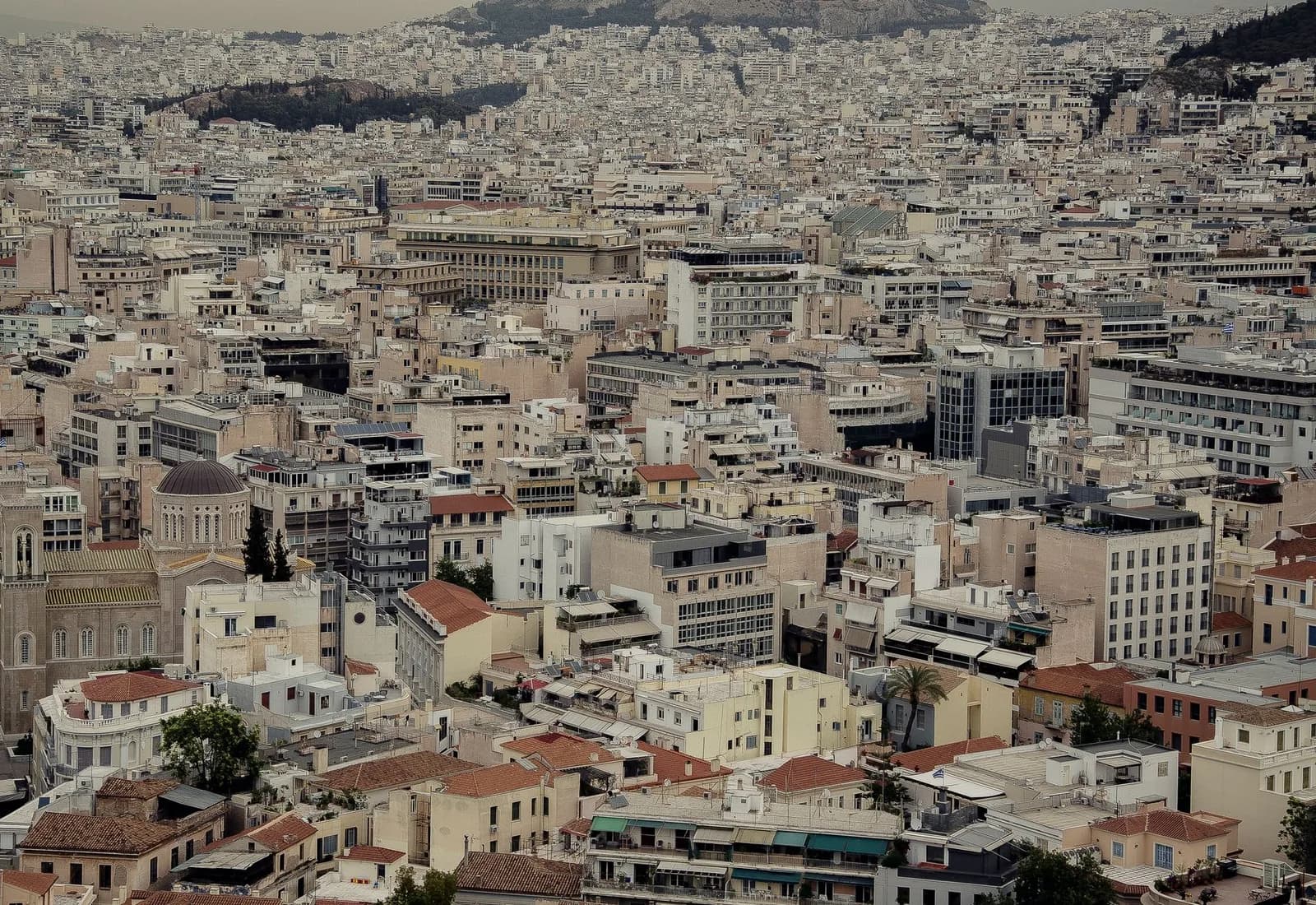 Dense urban cityscape of Athens with traditional architecture and rooftops.