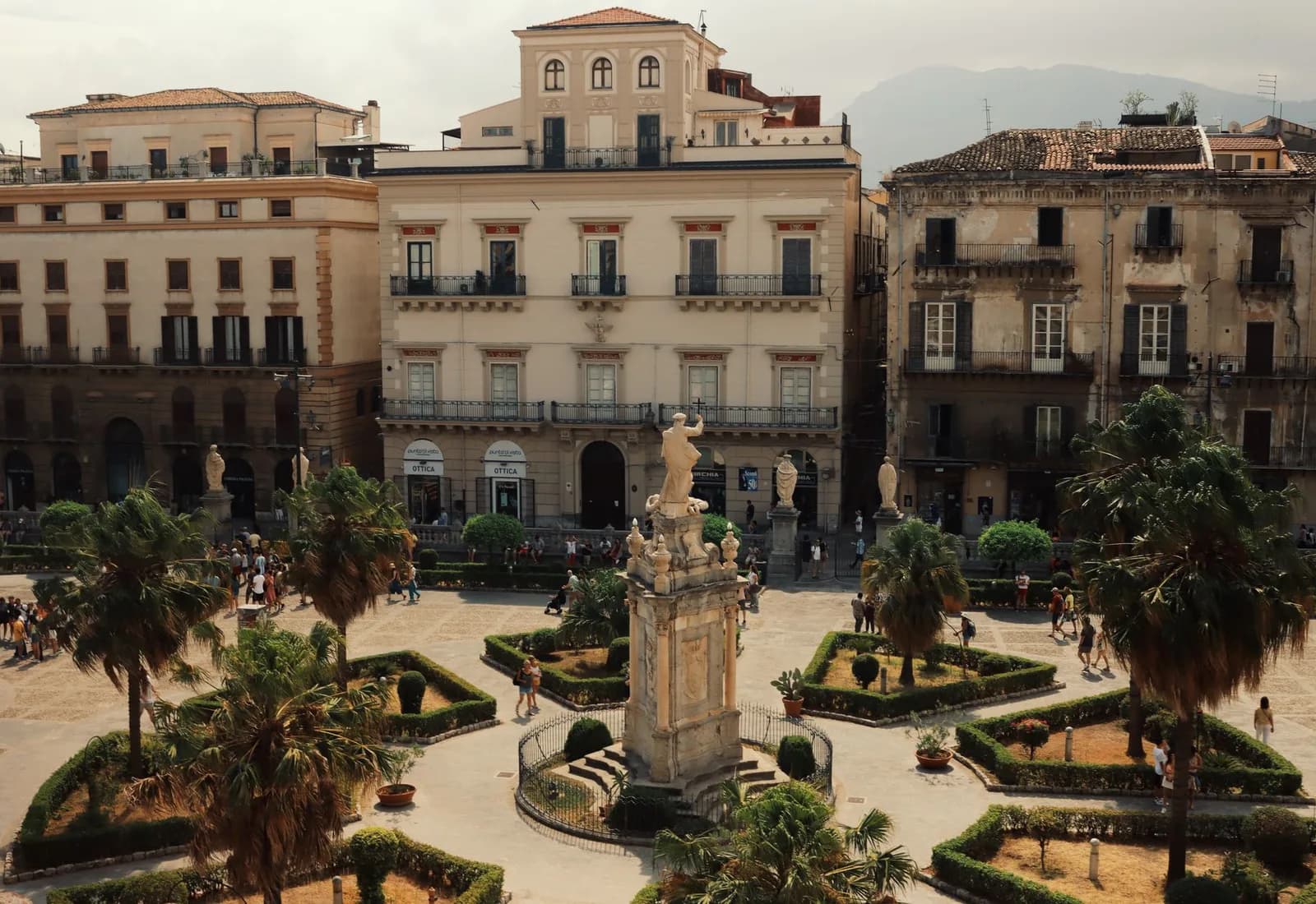 Aerial shot of a historic piazza in Palermo, Italy with landmarks and urban architecture.